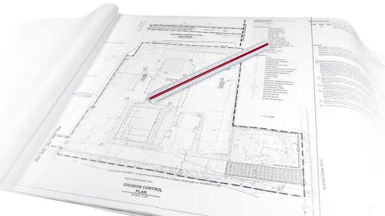 Engineering plan document with a ruler laid on top